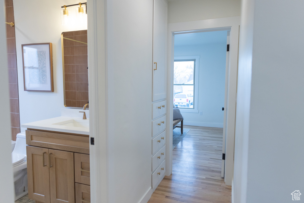 Full bathroom featuring toilet, vanity, and wood finished floors