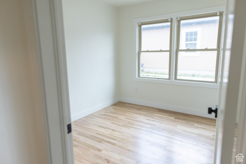 Unfurnished room with baseboards and wood finished floors