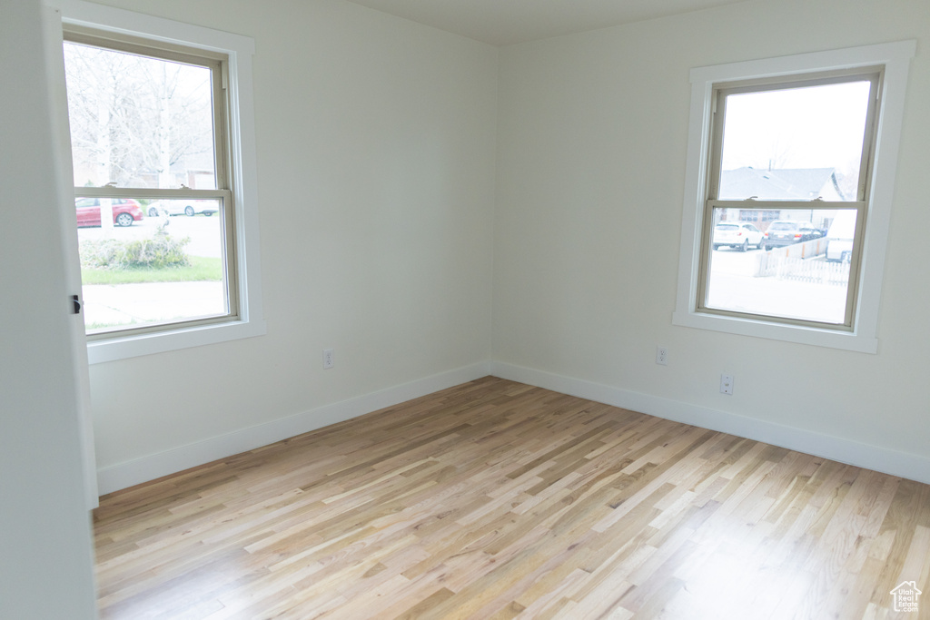 Spare room featuring baseboards and light wood-style flooring