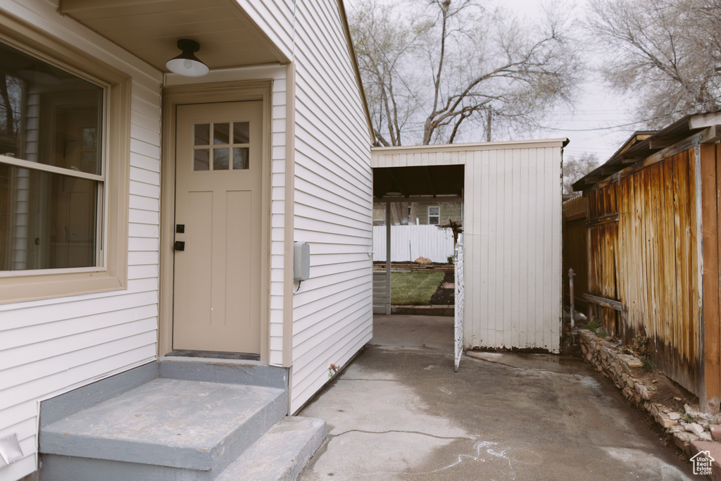 View of exterior entry featuring fence