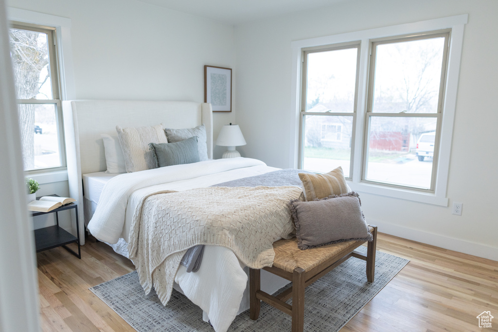 Bedroom with light wood finished floors and baseboards