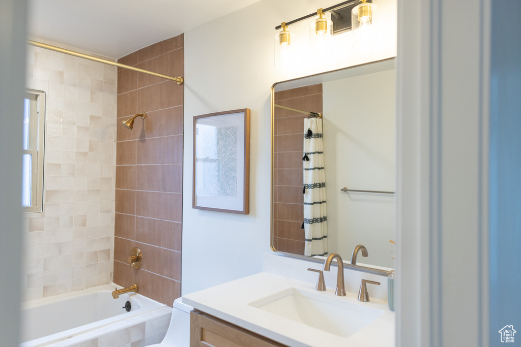Full bath featuring toilet, shower / tub combo with curtain, and vanity