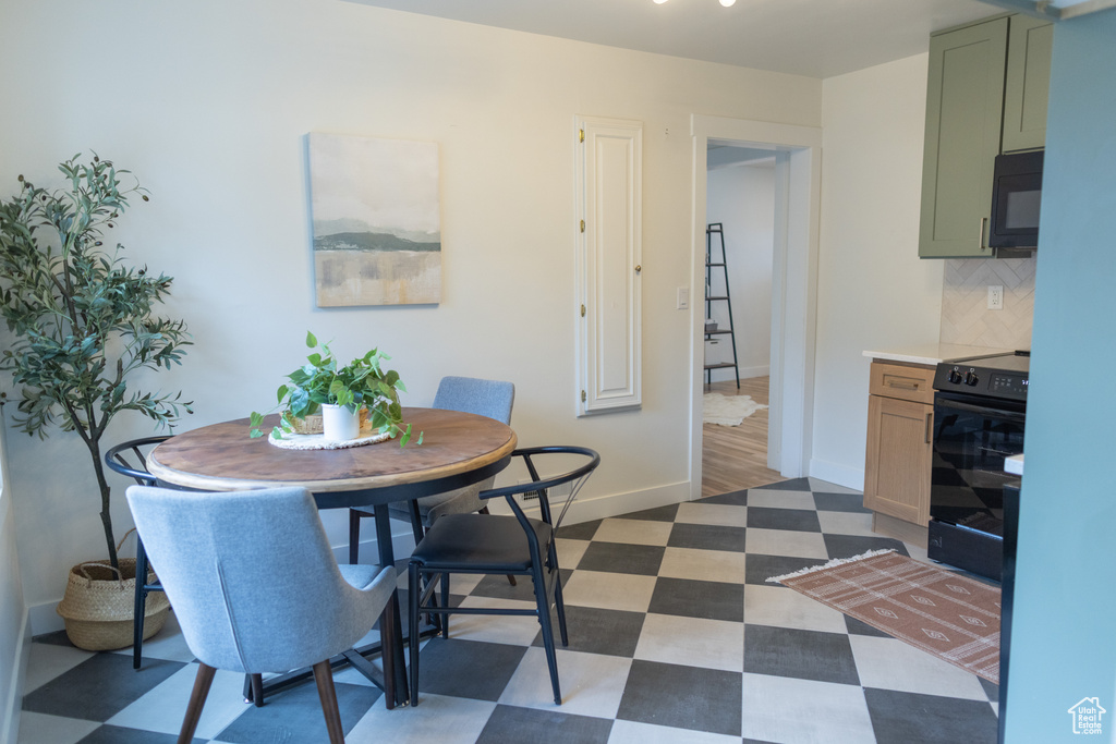 Dining area with baseboards and dark floors