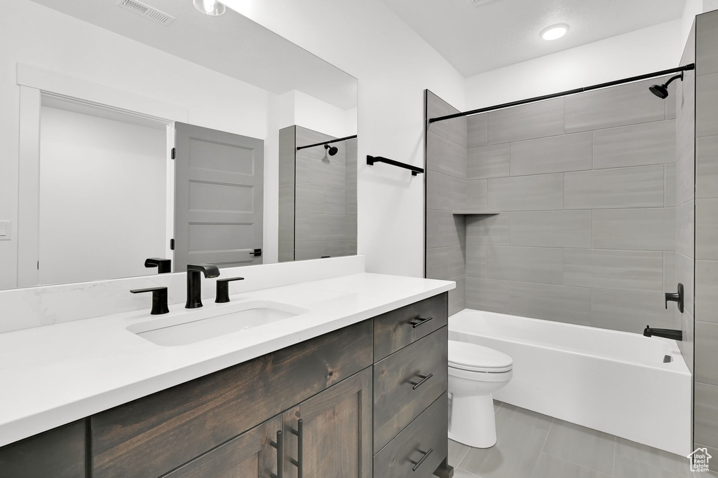Full bath featuring shower / tub combination, tile patterned flooring, vanity, toilet, and visible vents
