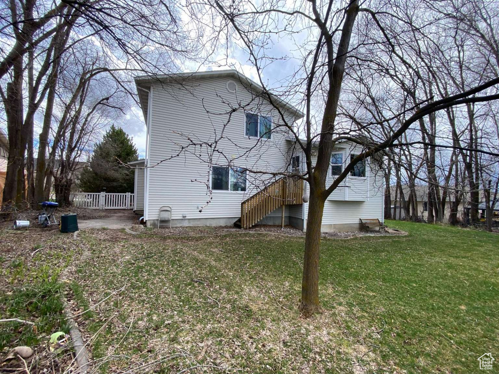 Back of house with a lawn