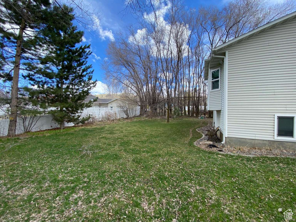 View of yard featuring fence
