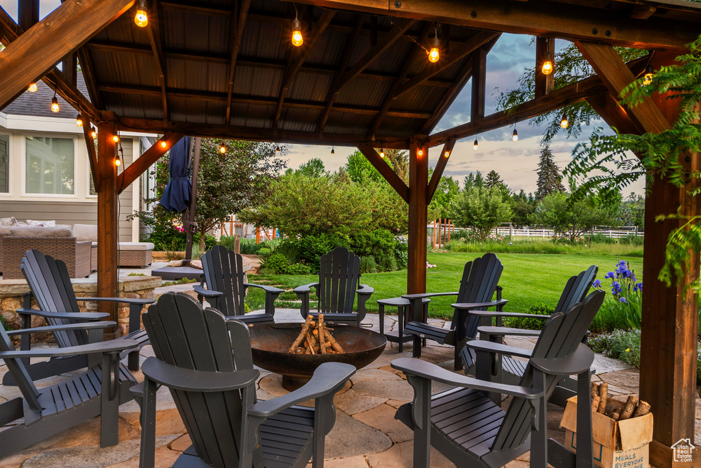 View of patio / terrace featuring an outdoor fire pit and a gazebo