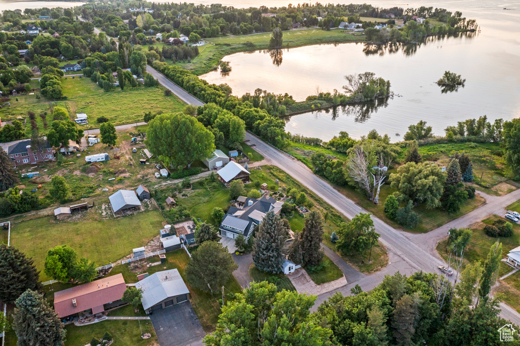 Aerial view of property and surrounding area with a nearby body of water