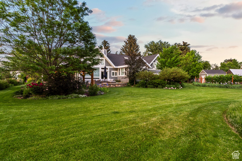 View of green lawn with a patio
