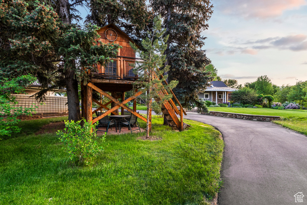 View of front of property with a front yard and driveway