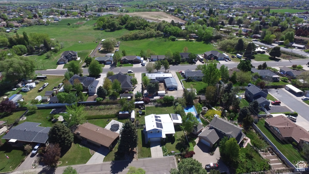 Aerial view of property and surrounding area featuring nearby suburban area