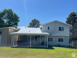 Rear view of property with a patio area