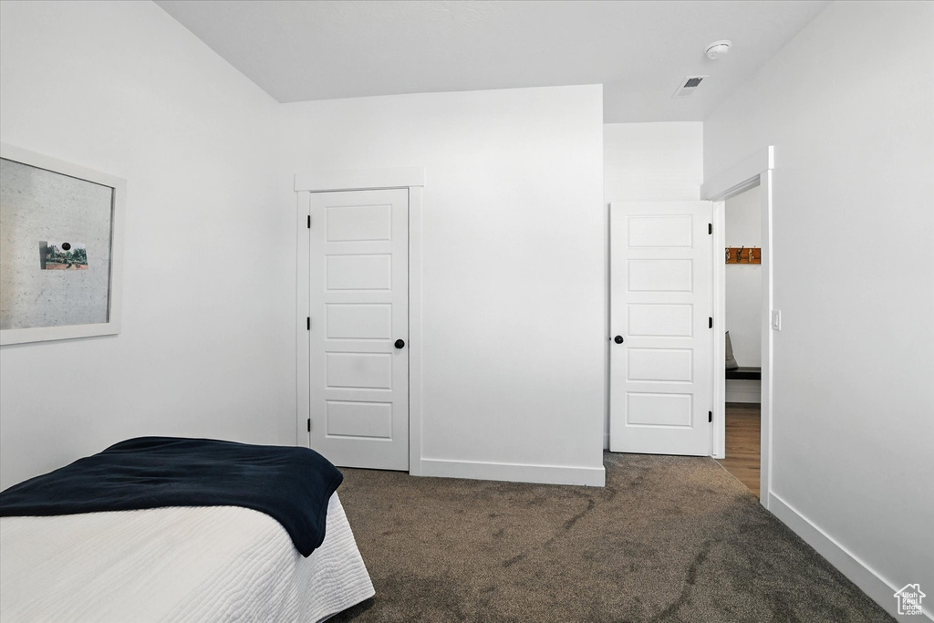 Carpeted bedroom featuring baseboards