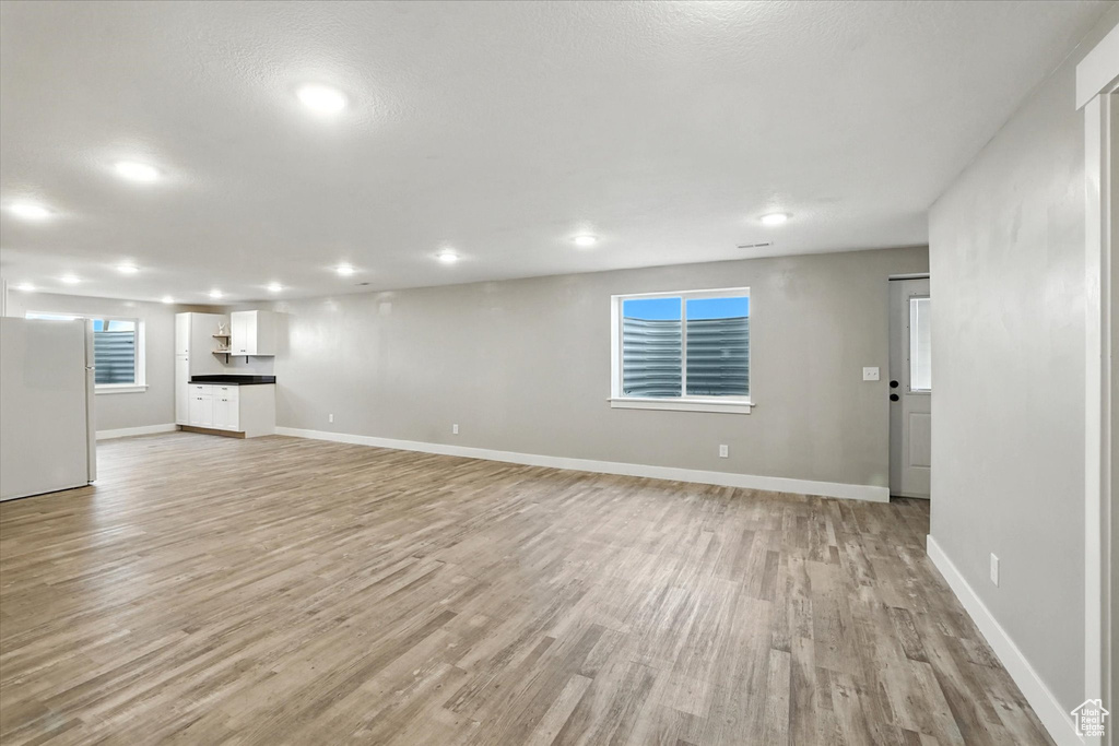 Unfurnished living room featuring light wood-style floors and recessed lighting