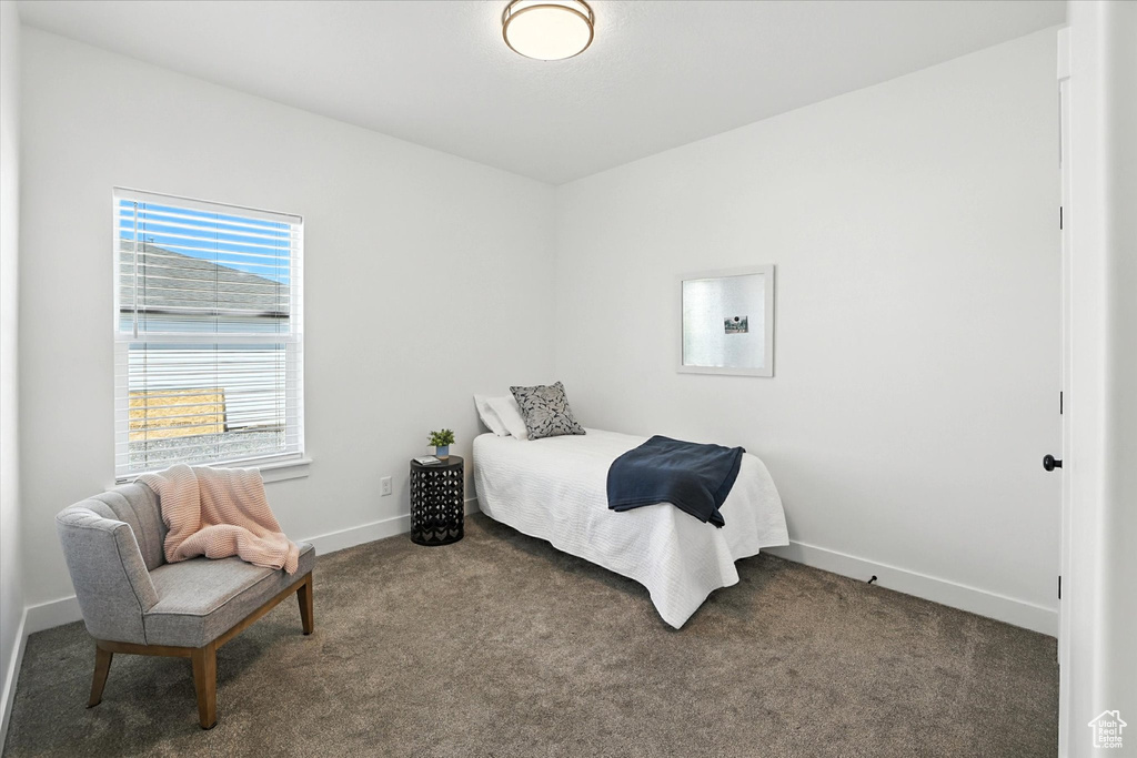 Bedroom featuring carpet flooring and baseboards