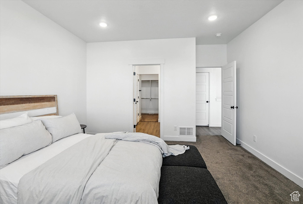 Carpeted bedroom with baseboards and recessed lighting