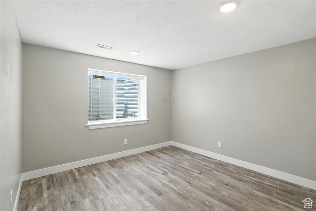 Empty room featuring wood finished floors and baseboards