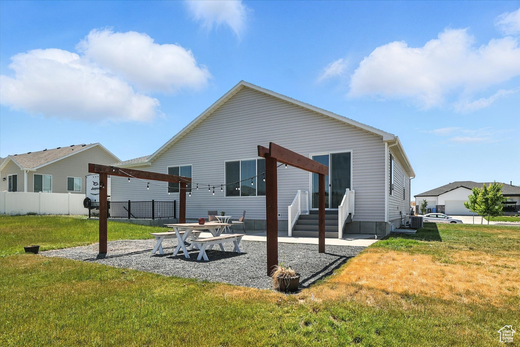 Back of house with a patio