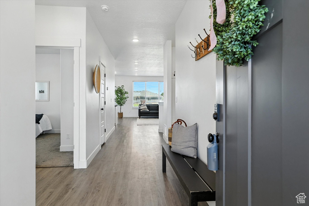 Hallway with wood finished floors and baseboards