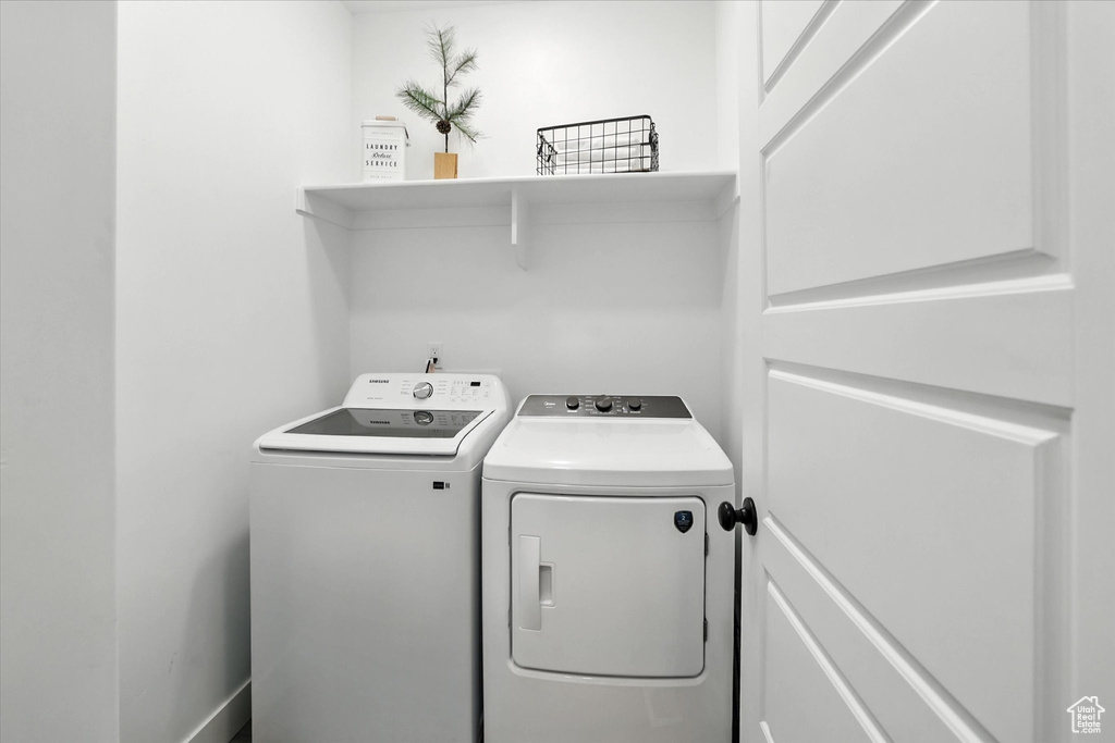 Washroom with washer and clothes dryer