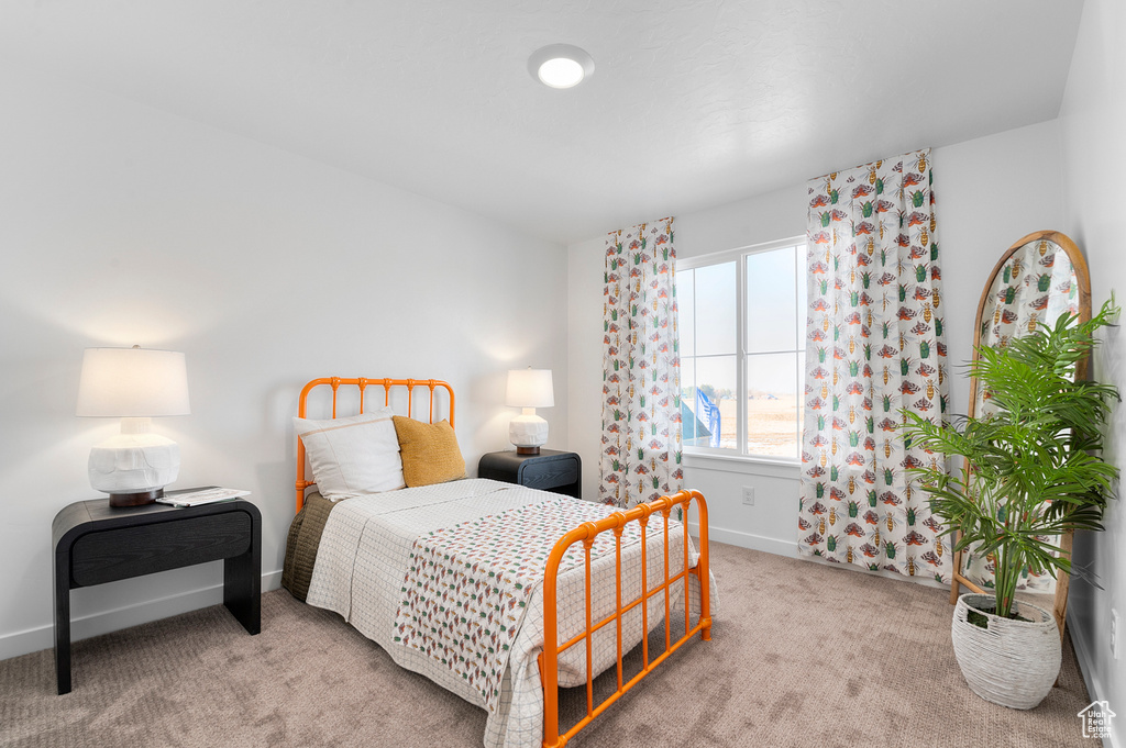 Bedroom featuring baseboards and carpet floors