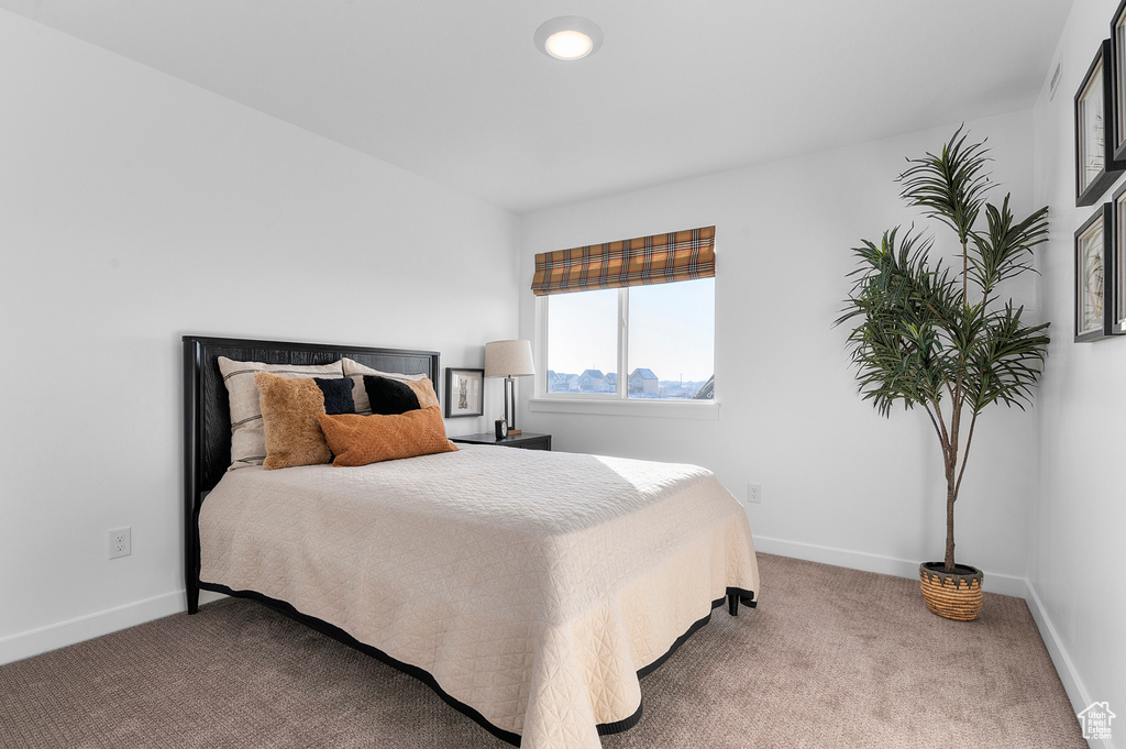 Carpeted bedroom featuring baseboards