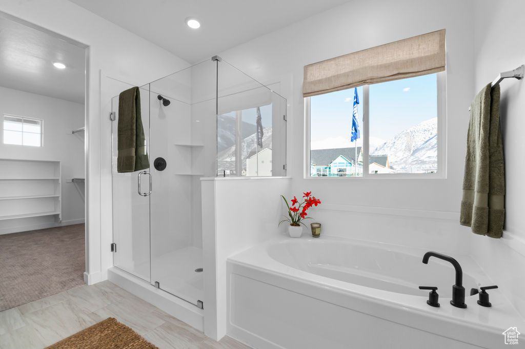 Full bathroom featuring recessed lighting, a shower stall, and a bath