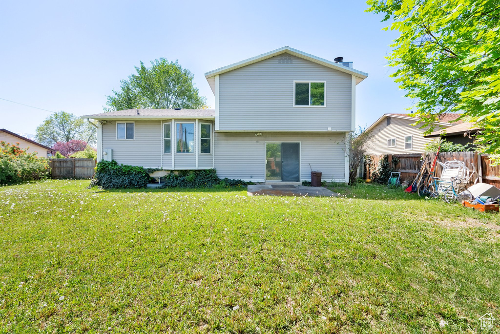 Rear view of property featuring a patio