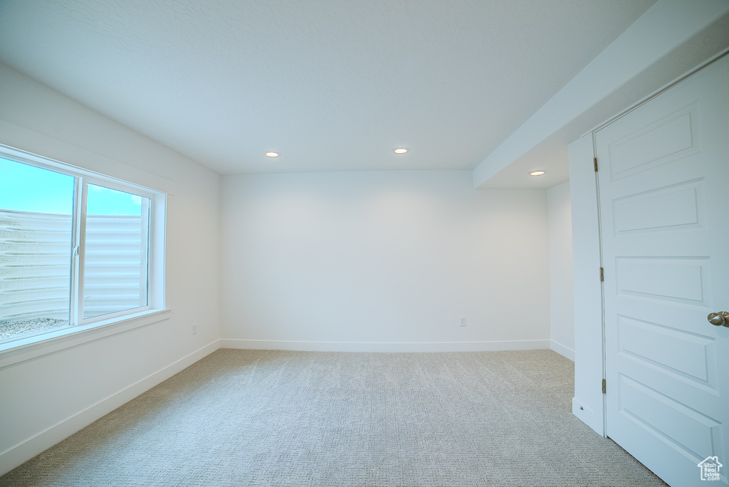 Spare room featuring recessed lighting, baseboards, and light colored carpet