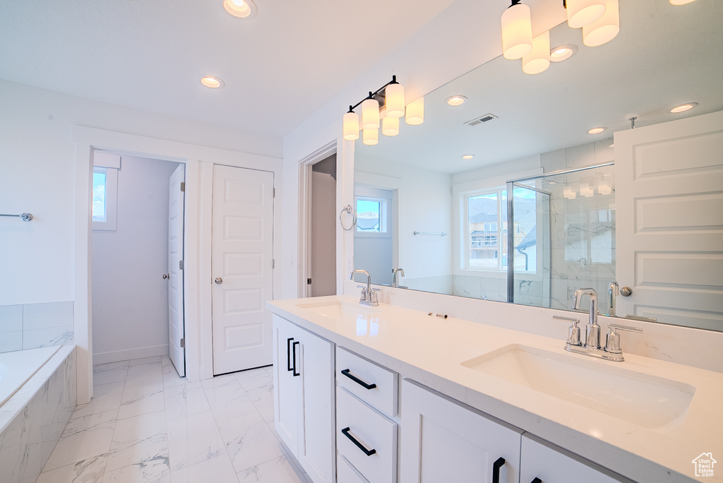 Bathroom featuring visible vents, a sink, a stall shower, and recessed lighting