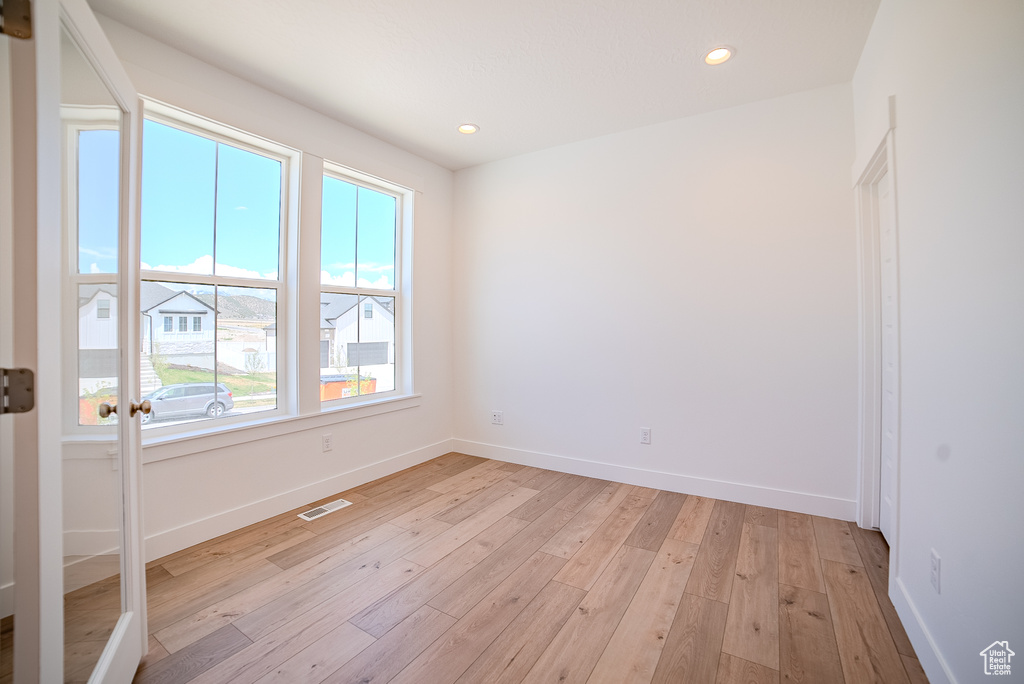 Spare room with recessed lighting, baseboards, visible vents, and light wood-style flooring