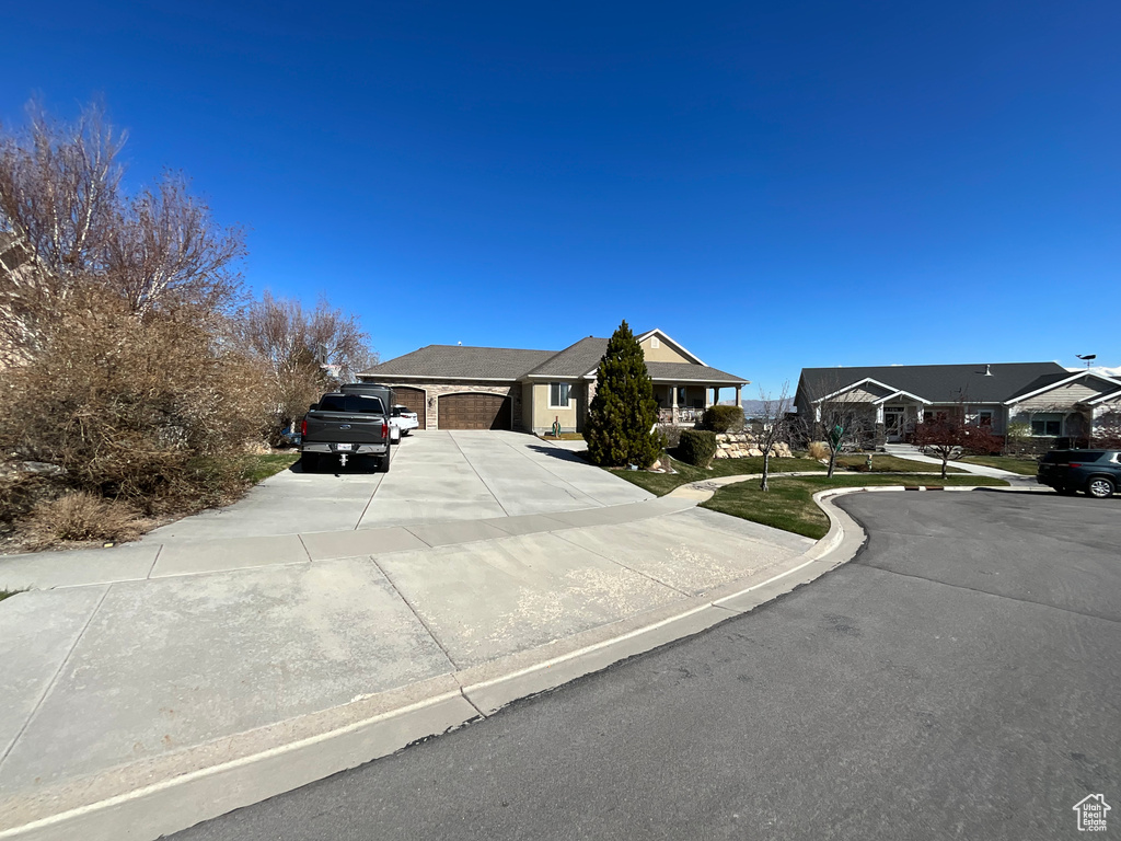 View of front facade with driveway and a garage