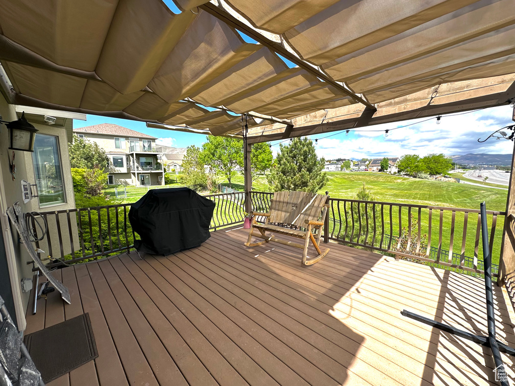 Wooden deck with a lawn and grilling area