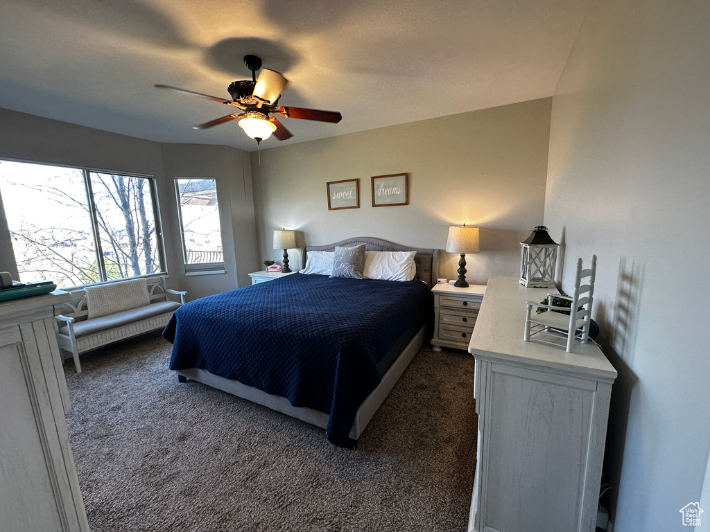 Bedroom featuring dark carpet and a ceiling fan