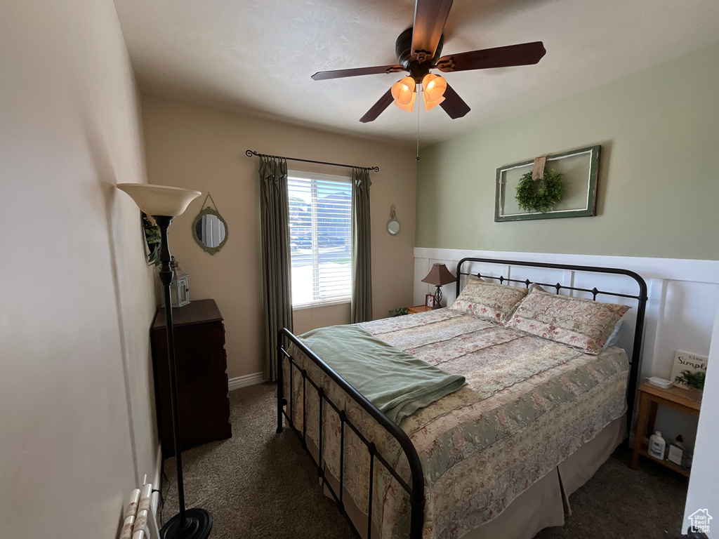 Bedroom featuring baseboards, carpet flooring, and ceiling fan