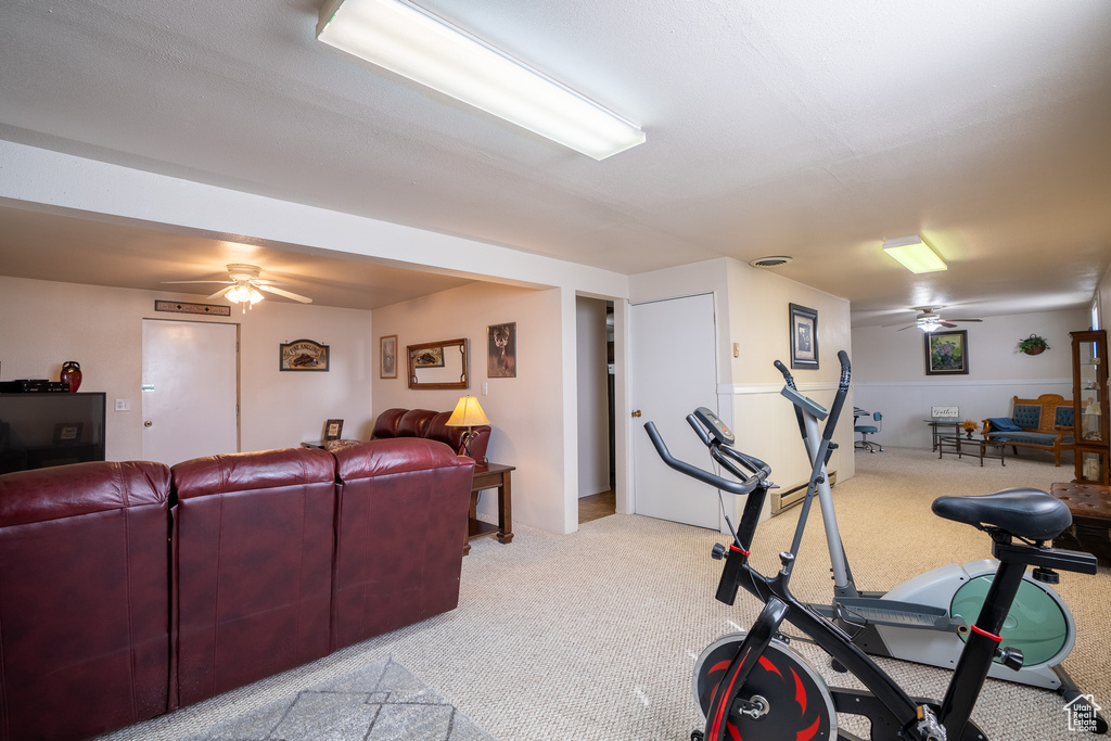 Workout area featuring light colored carpet and ceiling fan