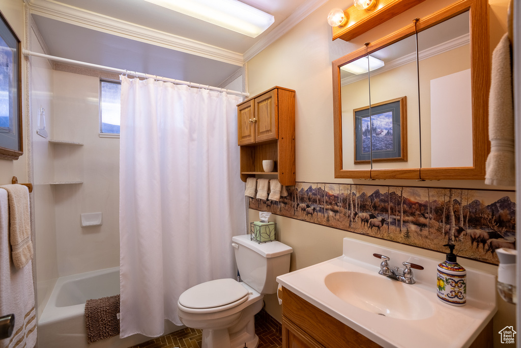 Full bath featuring shower / bath combination with curtain, toilet, vanity, and ornamental molding