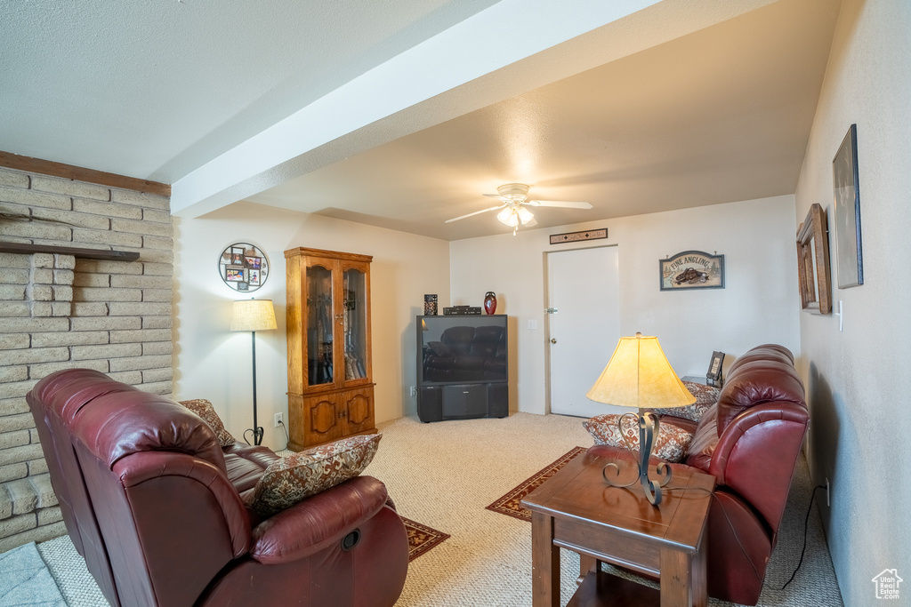 Living room with ceiling fan and carpet flooring