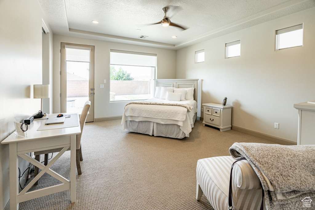 Bedroom featuring baseboards, visible vents, light colored carpet, and a textured ceiling
