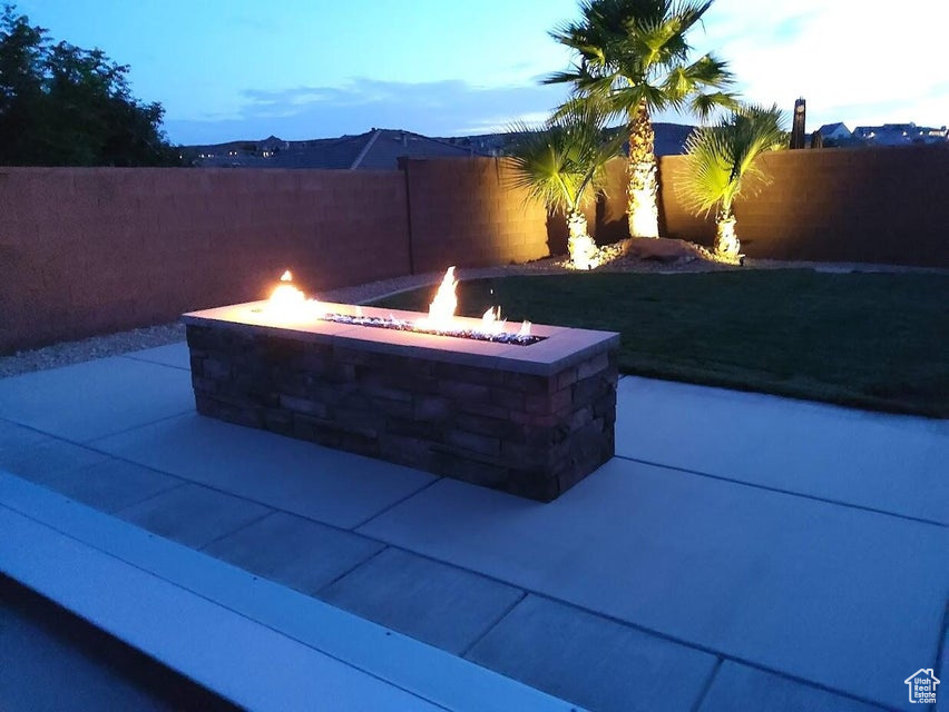 View of patio featuring a fenced backyard and a fire pit