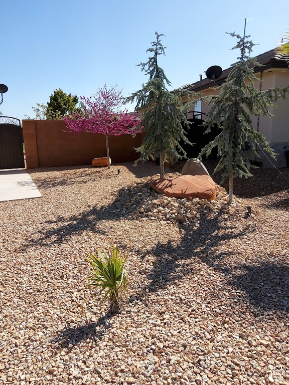 View of yard with fence and a gate