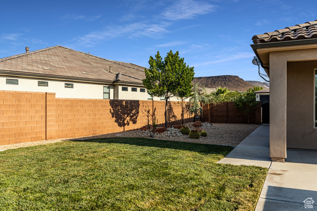 View of yard with a fenced backyard and a mountain view