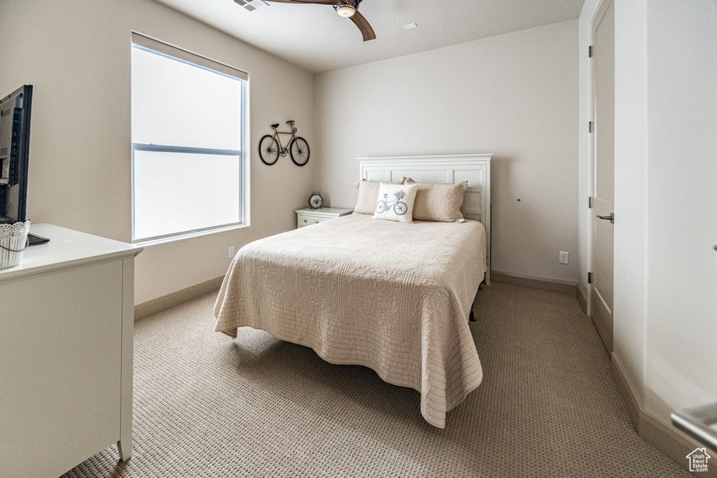 Bedroom featuring baseboards and light colored carpet