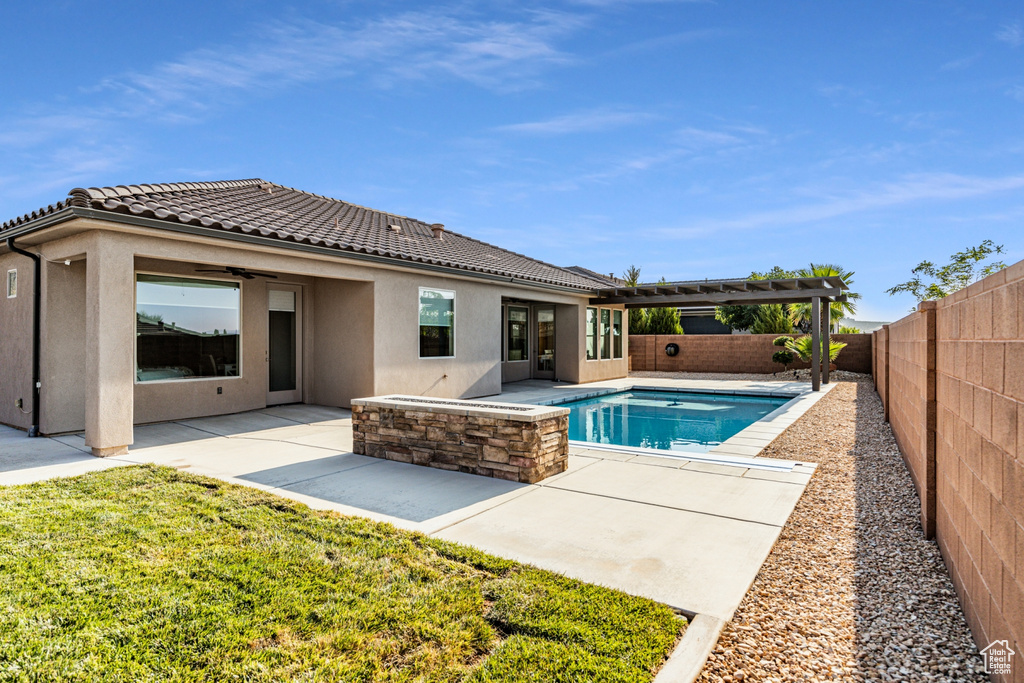 View of swimming pool with a patio, a fenced backyard, a fenced in pool, ceiling fan, and a pergola