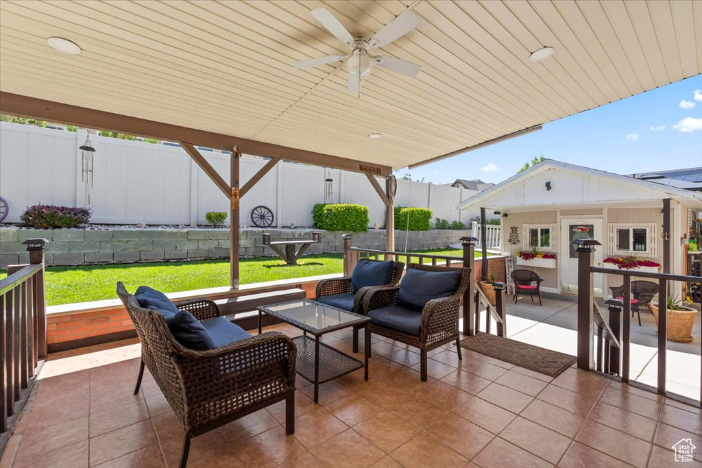 View of patio featuring an outdoor living space, an outdoor structure, and a ceiling fan