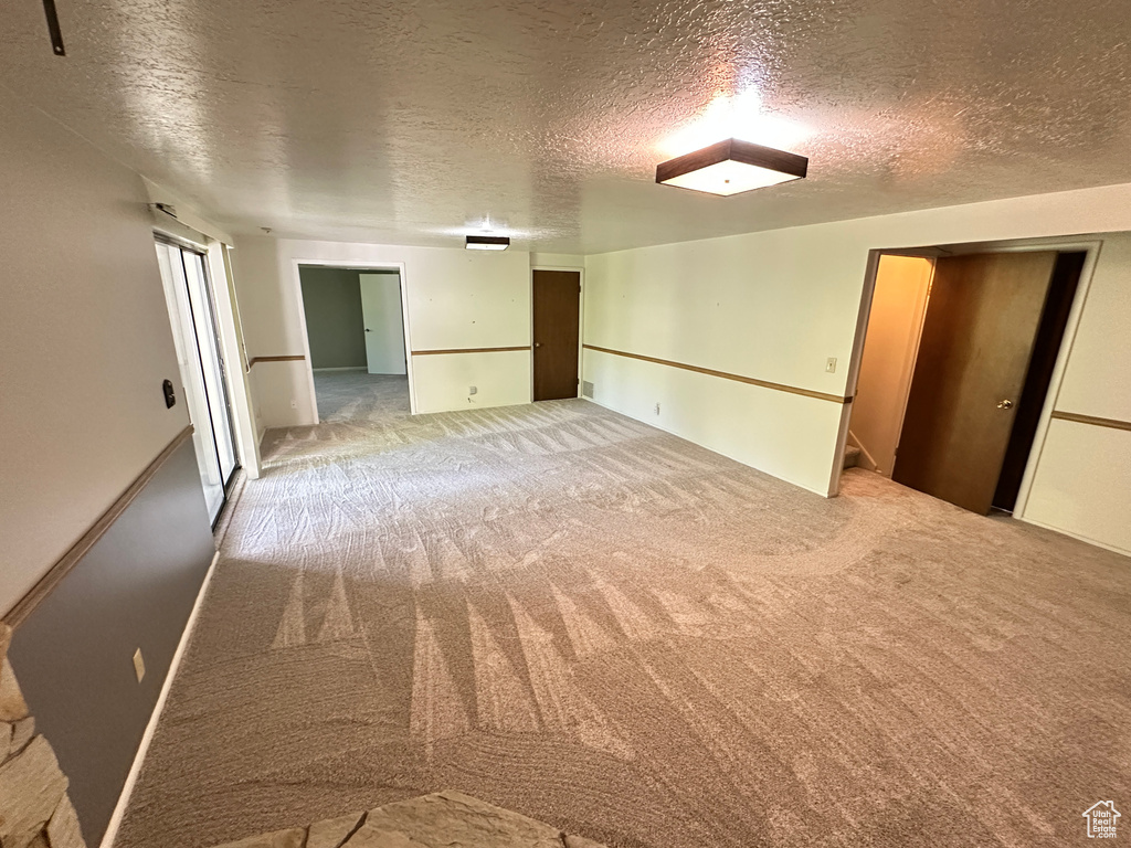 Spare room with carpet and a textured ceiling