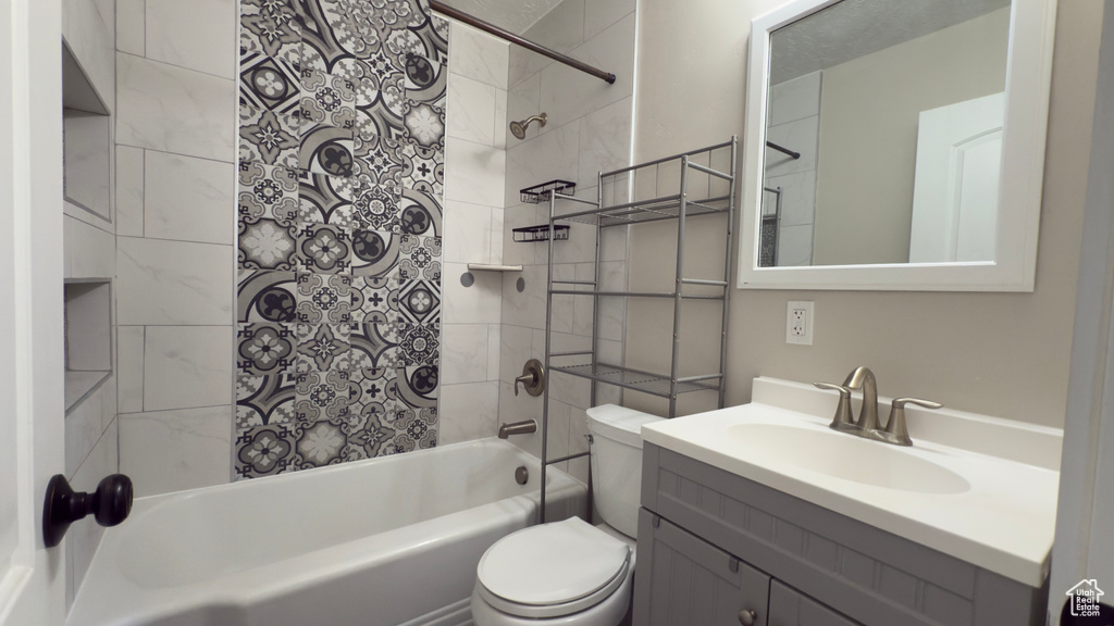 Full bath with bathtub / shower combination, toilet, and vanity