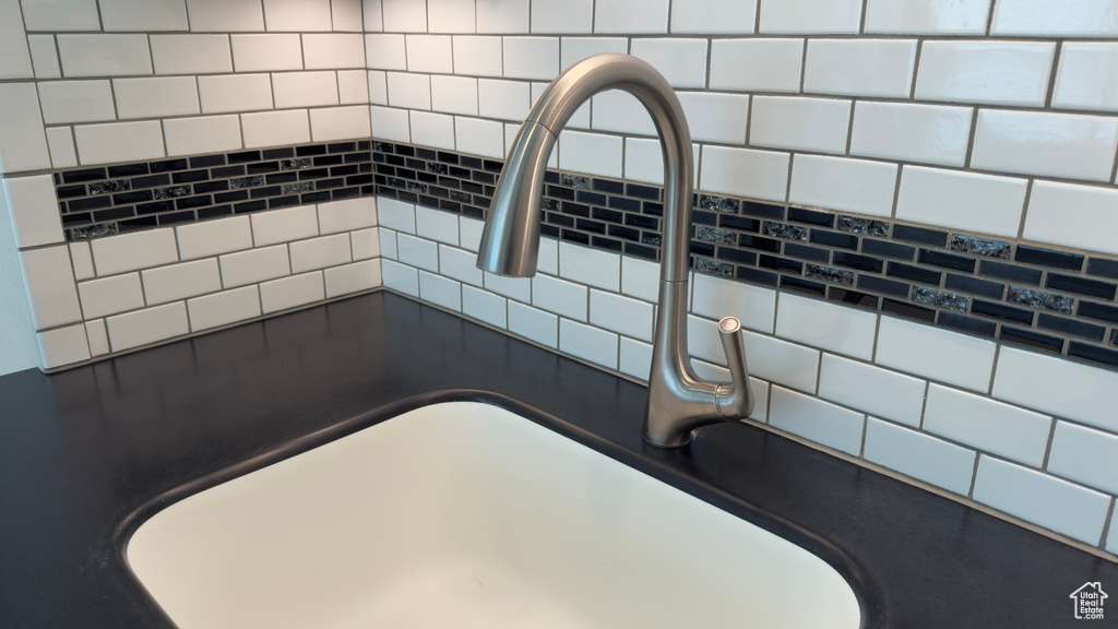 Room details featuring dark countertops and a sink