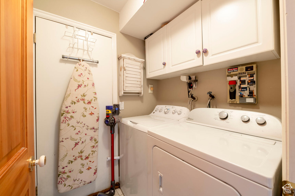 Laundry room with separate washer and dryer and cabinet space