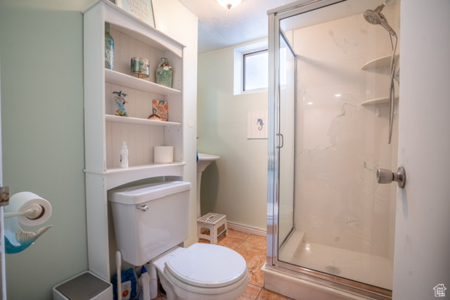 Bathroom with a stall shower and toilet